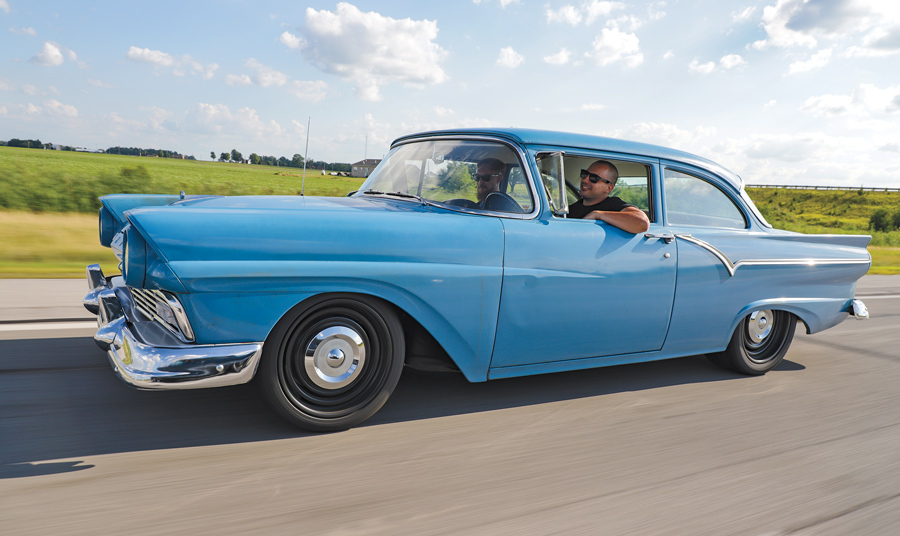 1957 Ford Custom driving down the highway
