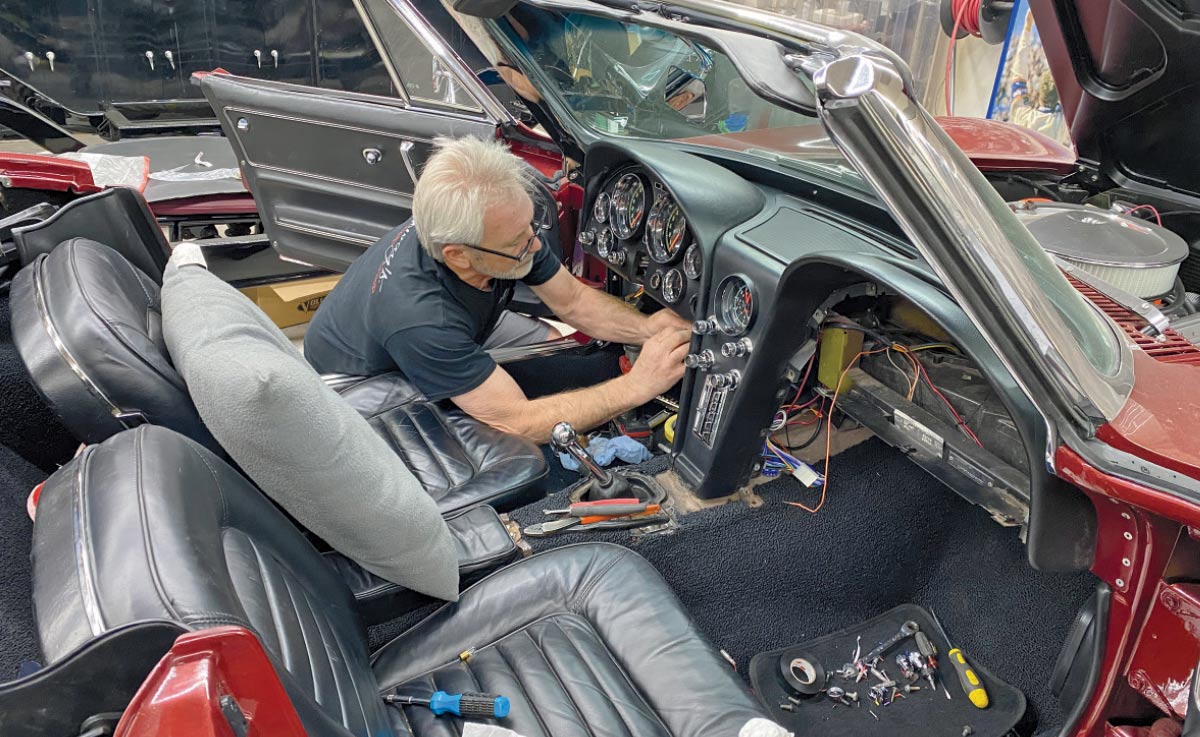 Image of Bobby Alloway attending to some wiring and dash installation