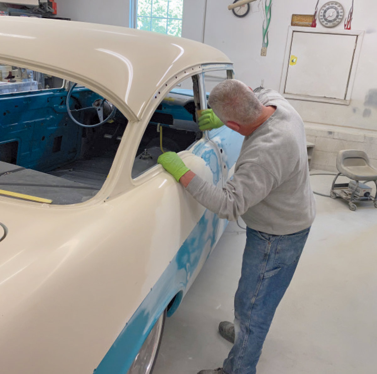 Picture of Jeff Plemons is busy carefully sanding window areas