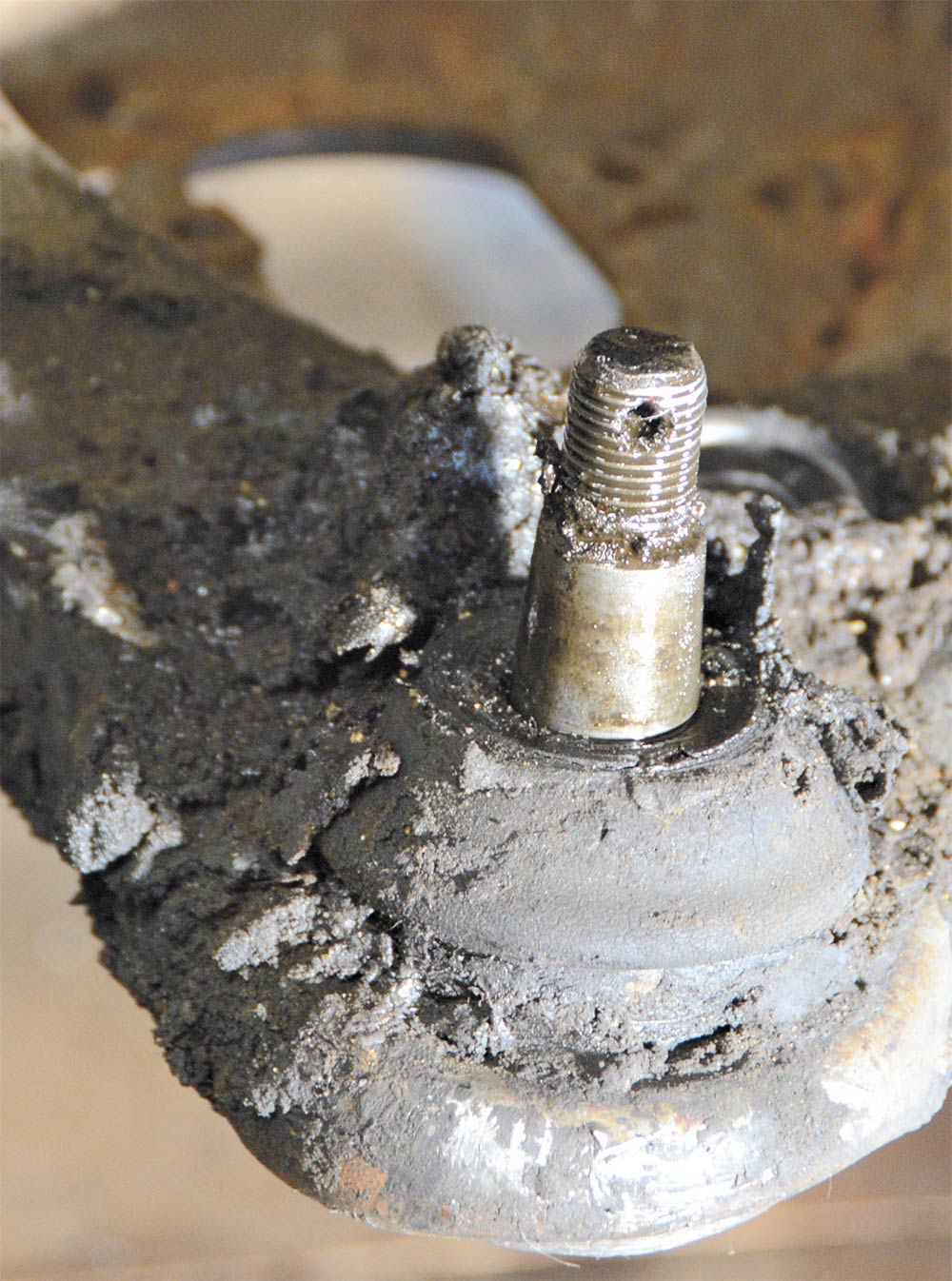 view of gobs of grease around a ball joint