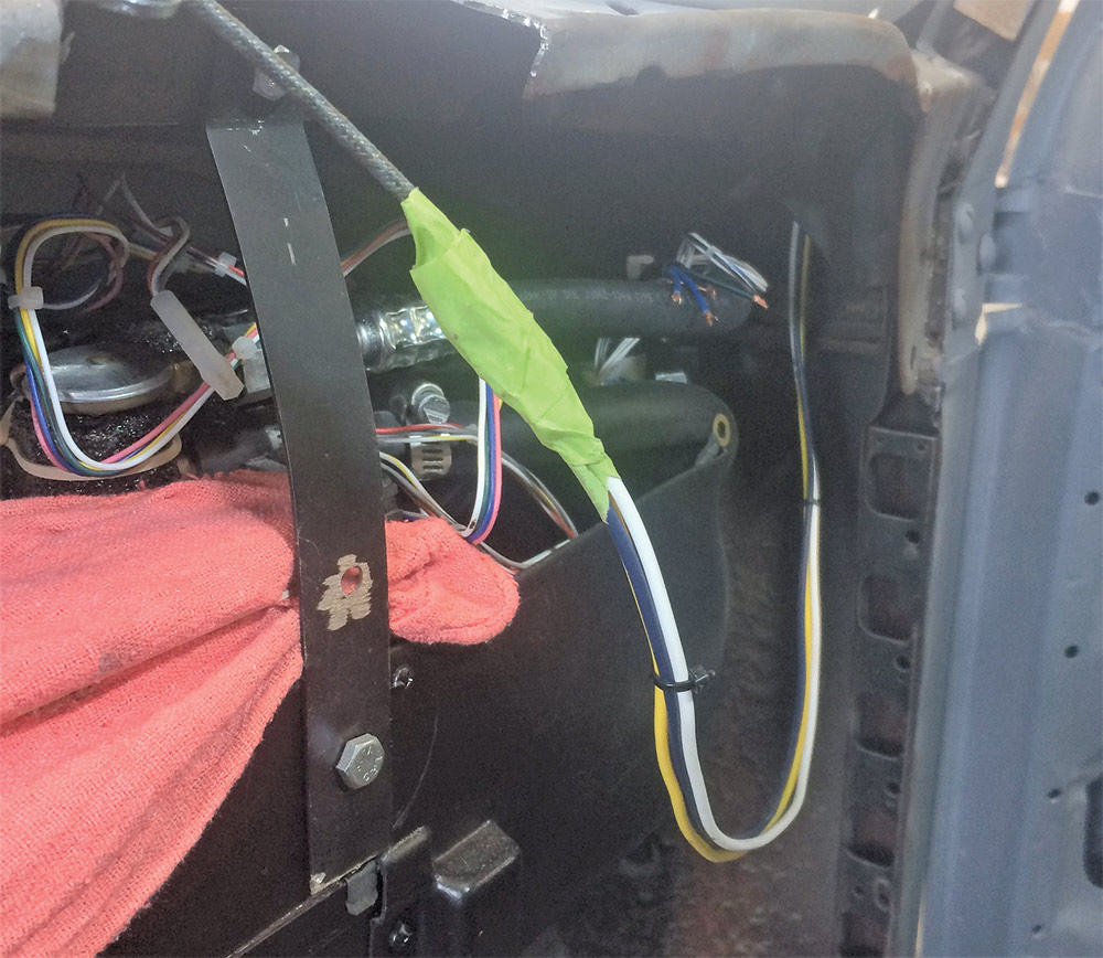 A lead on the wiper motor wires puled down through the A-pillar