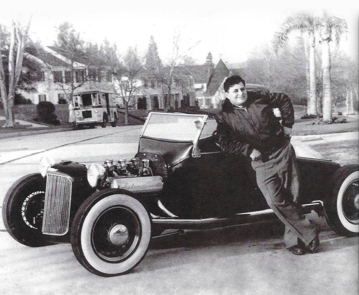 Ed Iskenderian leaning on car