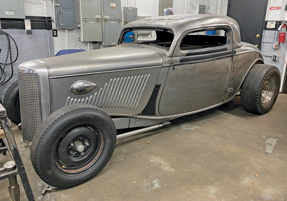 Front three quarter of 1933 three window Ford coupe in Hollywood Hot Rods shop