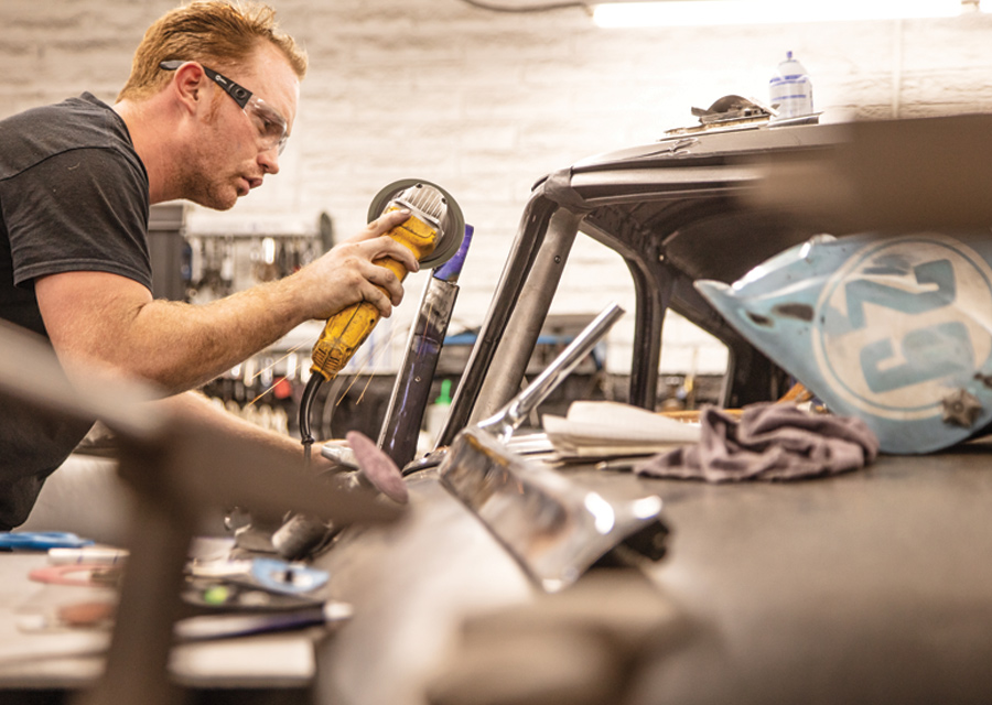 with a DeWalt 4-inch peanut grinder in hand, Sean Leger trims the doorpost for the custom-fabricated two-door hardtop door made for the 1956 Plymouth wagon