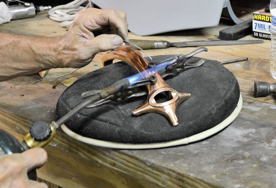 21: Once again, the propane torch is used for the soldering process