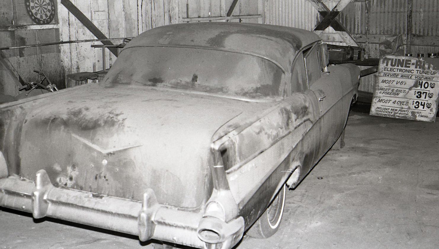 Rear view of an old Chevy in a garage