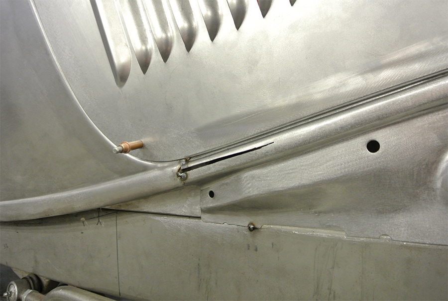 A single Cleco fastener holding the hood in place above the apron