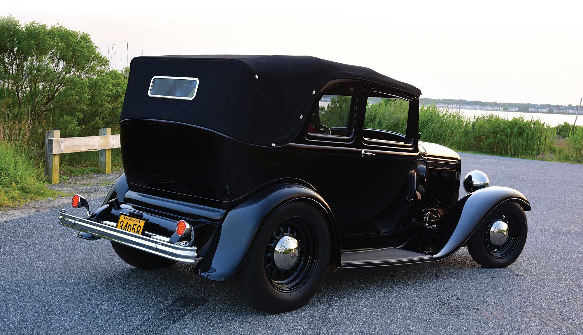 1932 Ford B-400 side profile displayed on cement road