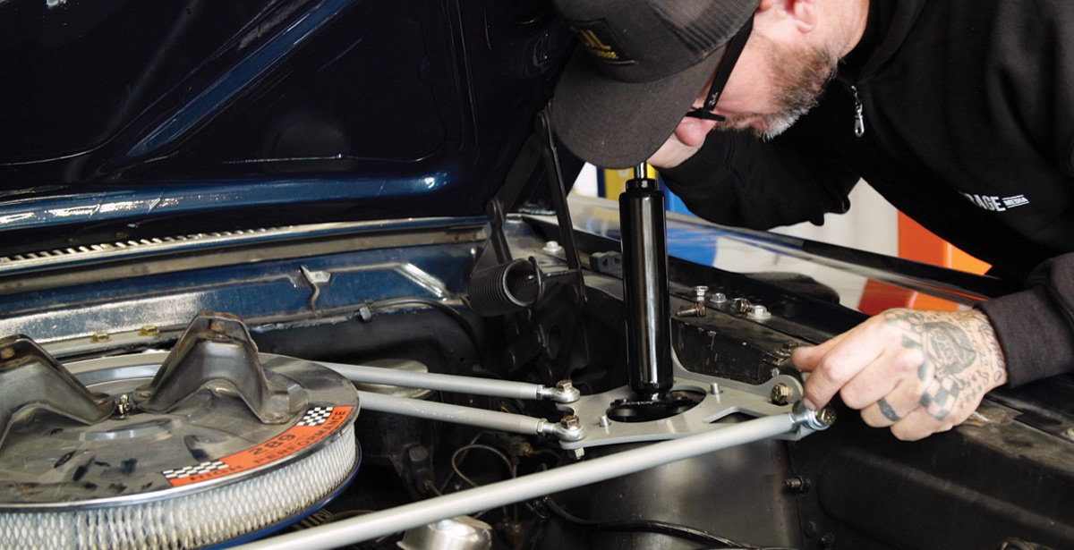 mechanic installs the front shocks