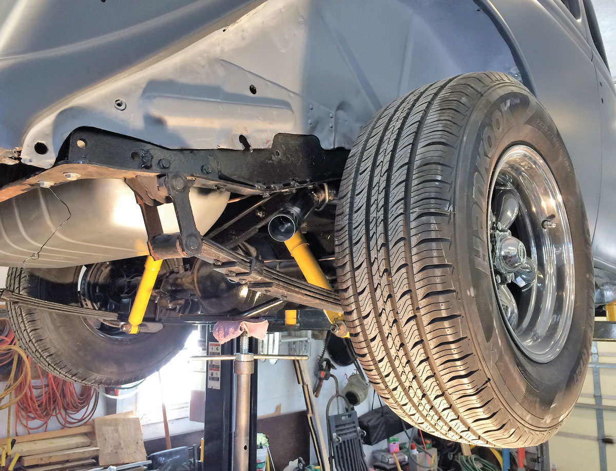 28: With the rear fender removed from the 1936 Ford you can see where the exhaust, minus tip, comes out in the rear below the framerail, behind the tire, and above the leaf spring package