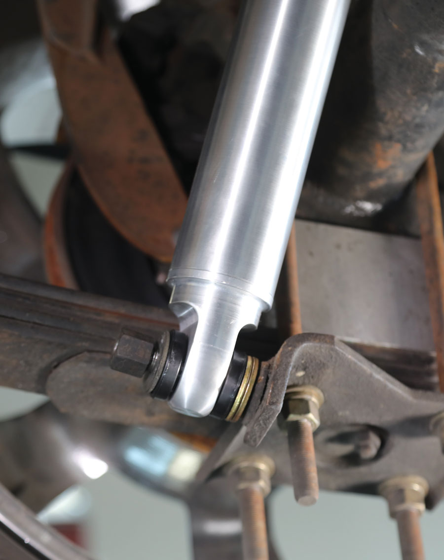 27: At the bottom the rear shocks attach to the original studs on the lower spring plate