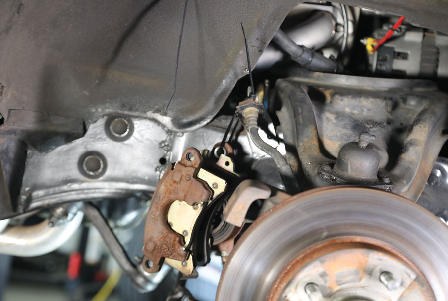 3: To prevent damage to the brake hoses when the spindles were separated from the lower control arm, the calipers were removed