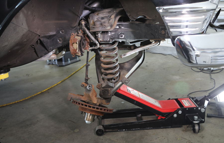 7: A floor jack was used to carefully lower the bottom control arms so the springs could be removed