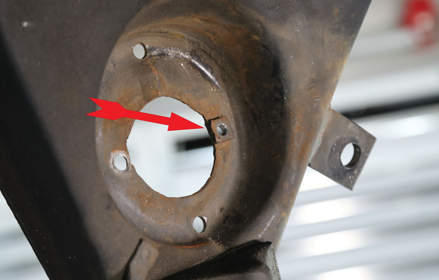8: The arrow points to one of the factory nuts attached to the lower control arm that were used to secure the lower shock mounts