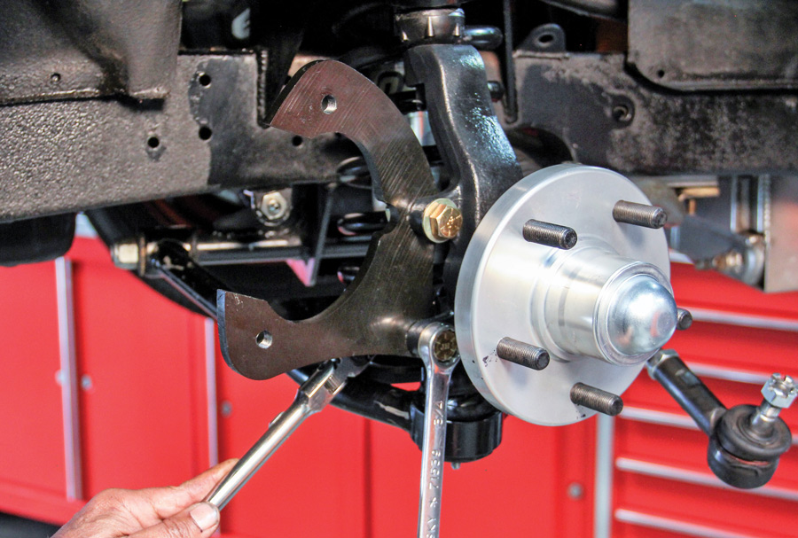 Install the disc brake caliper bracket to the back side of the spindle