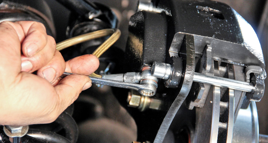 Use the provided banjo bolt with its copper compression washers (two, one each side of bolt) to install the brake line to the caliper bottom