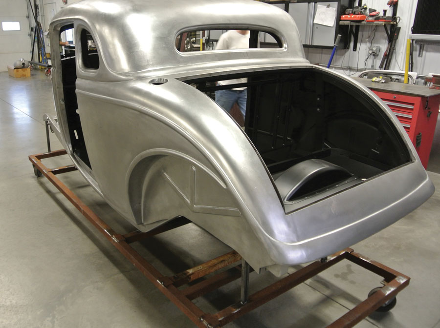 Here we see the finished quarter-panel after welding and metal finishing. Also note the gas fill opening has been formed in the upper driver side quarter-panel.