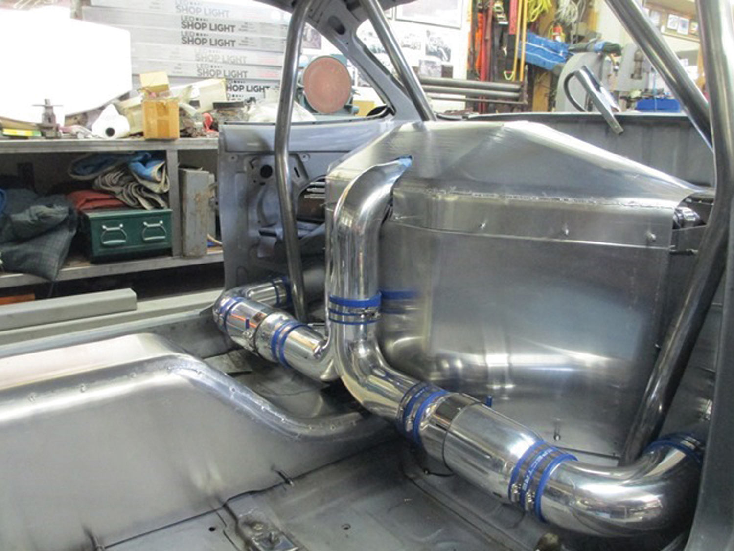 the engine’s air inlet tubes, running outside the engine cover