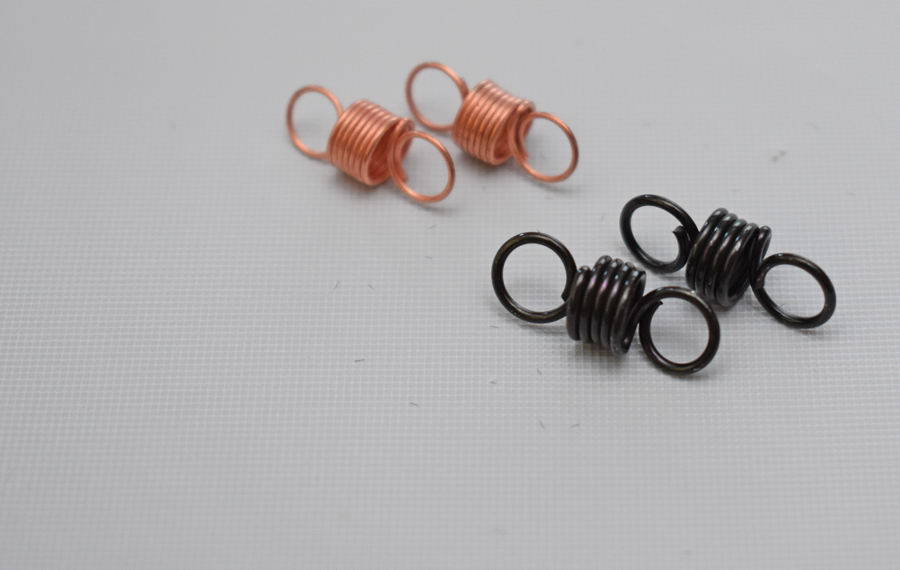 Two additional sets of springs are included with each distributor. The copper-colored springs provide the fastest advance curve with 5 degrees at 1,000 rpm and 24 degrees at 2,000 rpm. The black springs proved the slowest curve with 3 degrees at 2,000 rpm and 24 degrees at 5,000 rpm. It is possible to mix springs to produce custom curves.