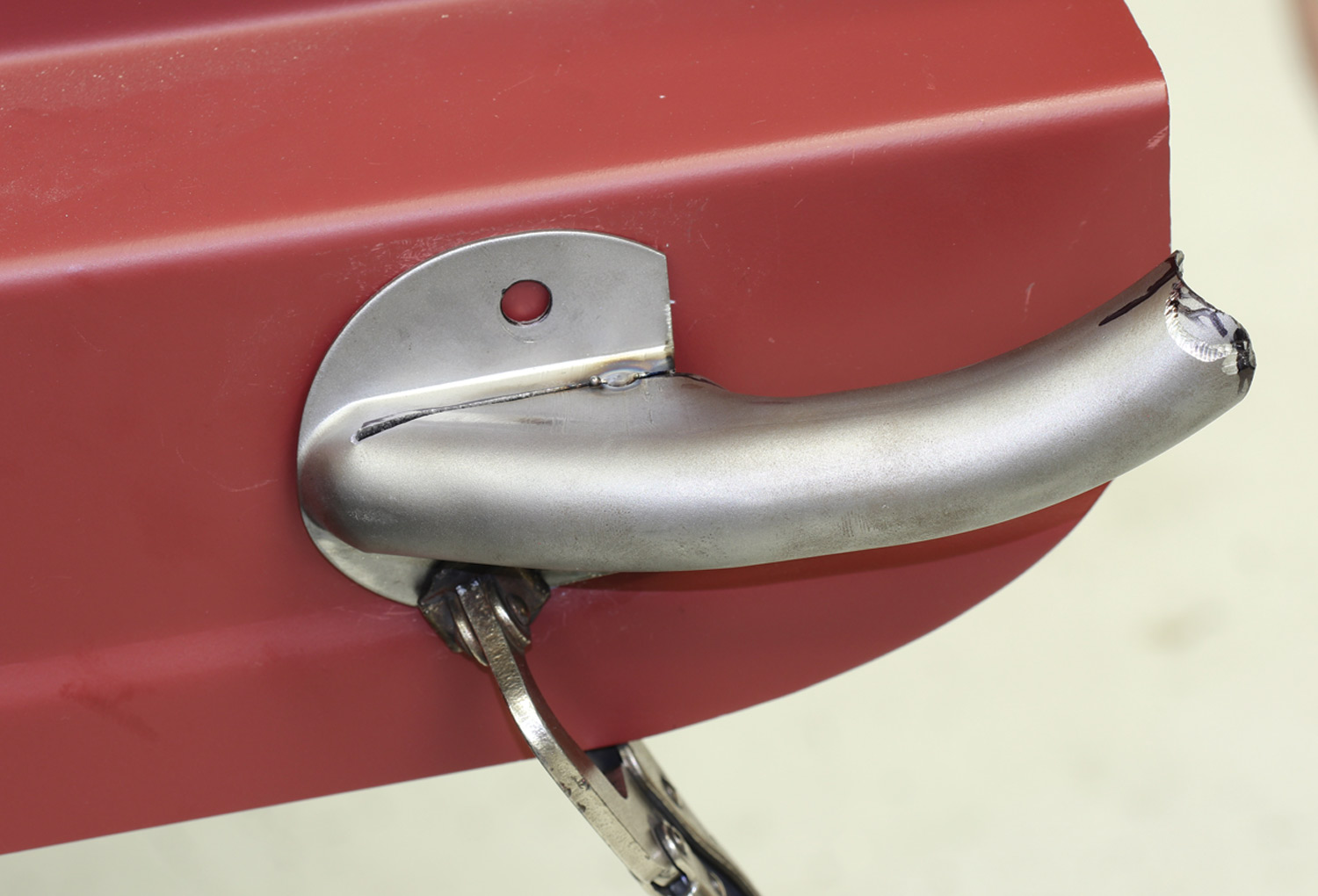 taillight stand is held in place by a clamp in preparation for drilling