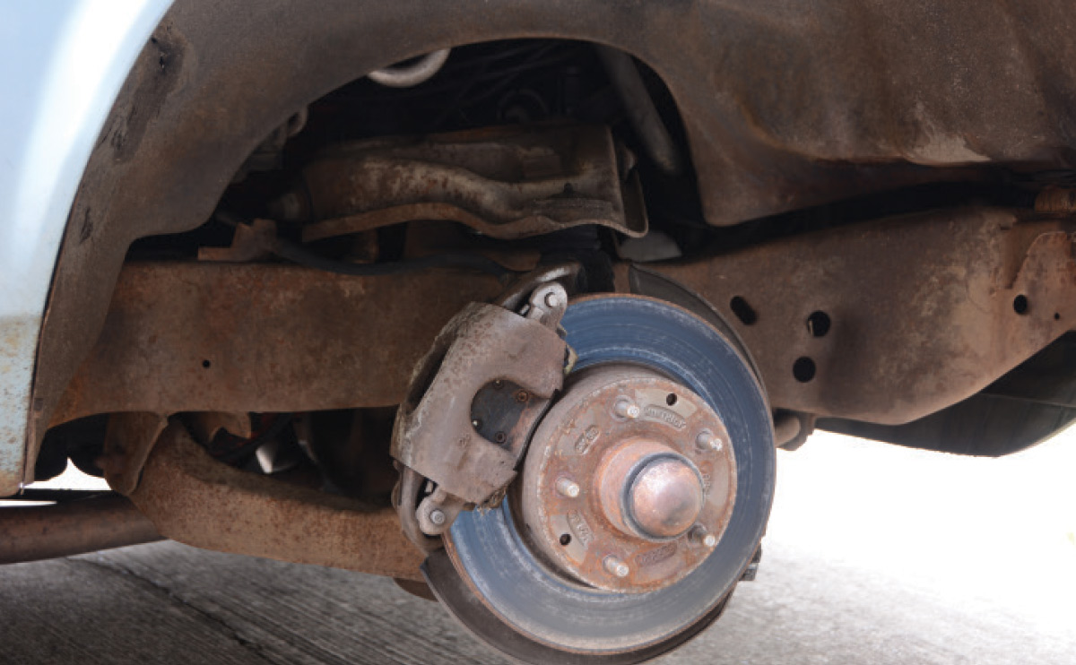 Surface rust has taken over the entire subframe, suspension, and braking components