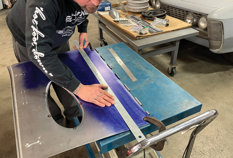 Once Shine has marked his distance from the hinge, he uses a long straightedge to scribe the center line for the first row of louvers.