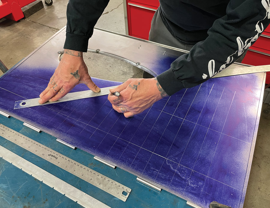 Once all three rows of louvers have been carefully laid out Shine uses a long straightedge to mark the diagonal so that he can see that the louvers have an even stagger and do not interfere with the blister.