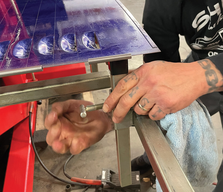 As the hood side moves through the press, shine brings his supports into play to make sure the panel stays square. These supports are especially important when punching large panels and hoods.