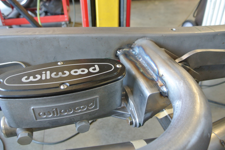 The Wilwood master cylinder mounts under the floor to maintain a clean firewall. Note the exhaust tubing is kept several inches away from the master cylinder. Brake fluid does not like heat.