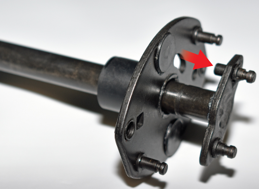 Here the distributor shaft has been pulled up from the advance plate—note the pin (arrow) that fits into the slot advance plate.