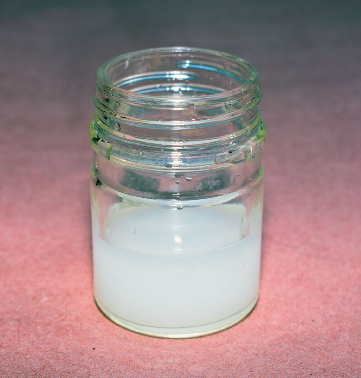 small glass jar containing glycol brake fluid mixed with water