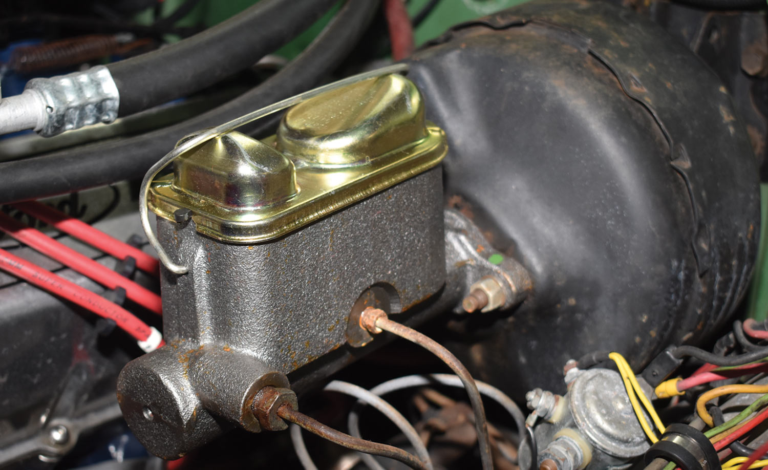 close view of a typical OEM vacuum booster and tandem master cylinder in a car