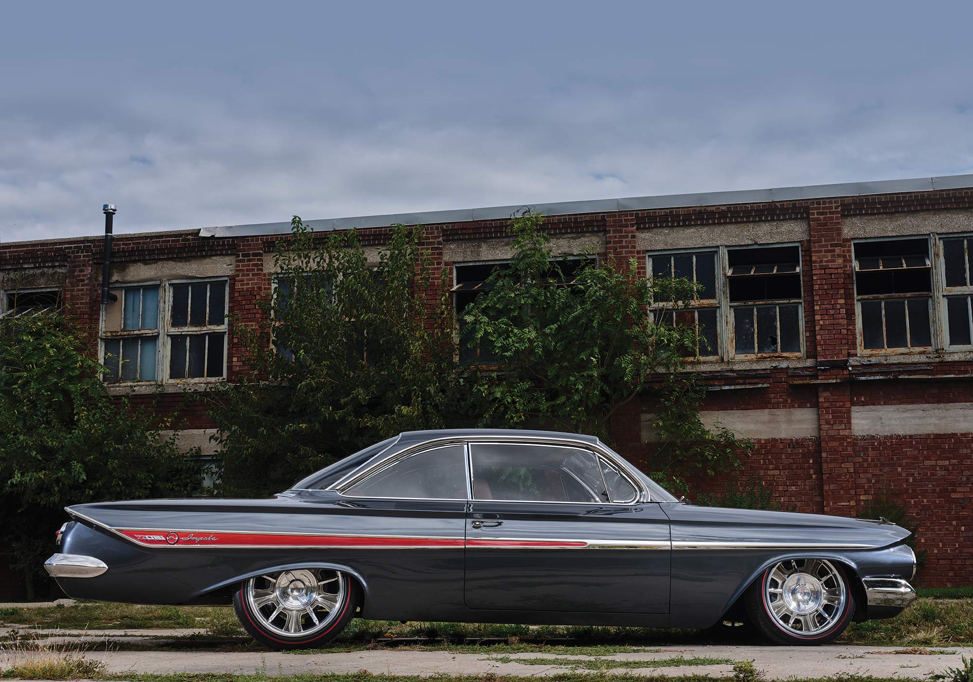 '61 Chevy Impala side profile with a brick building behind