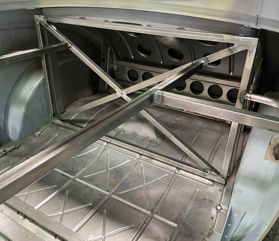 This is the rear bracing that Evan Veazie installed behind the doors of  Fortie’s Brookville Roadster three-window coupe. The longitudinal braces are anchored to a rectangular frame that itself is crossbraced and anchored to the floor and the body sides.