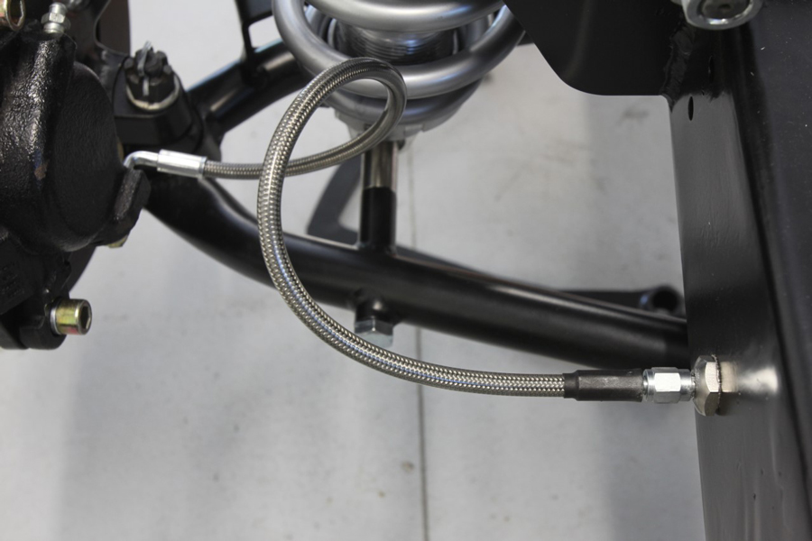 Often found with upgraded brakes are stainless steel flex lines. This is a -3 line with -3 fittings. Typically there are banjo or pipe thread adapter fittings found on the caliper. This application uses a through-the-frame AN fitting to connect to -3 stainless brake lines.