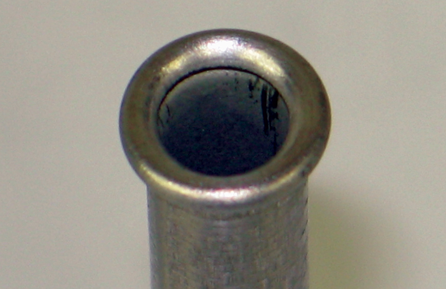 This is an example of an inverted double flare. The tubing is folded back onto itself to make a thick seat that is unlikely to crack. The angle of the sealing surface is 45 degrees.