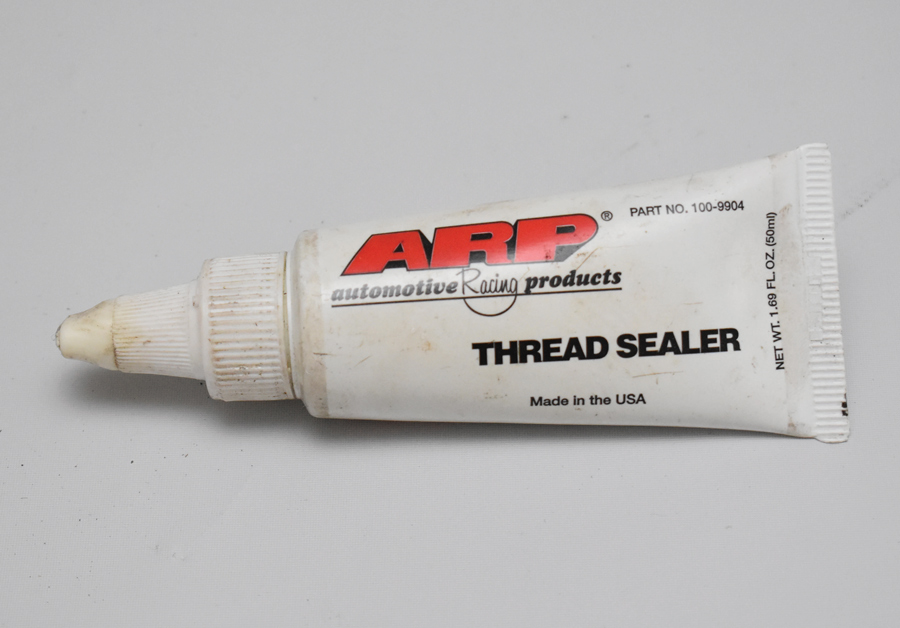 An alternative to Teflon tape is thread sealing paste. This example is from ARP.