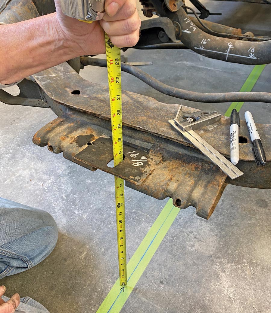 Before any modifications were made to the frame, a variety of measurements were taken and positions of components, including the core support bracket, were marked on the floor with a plumb bob.