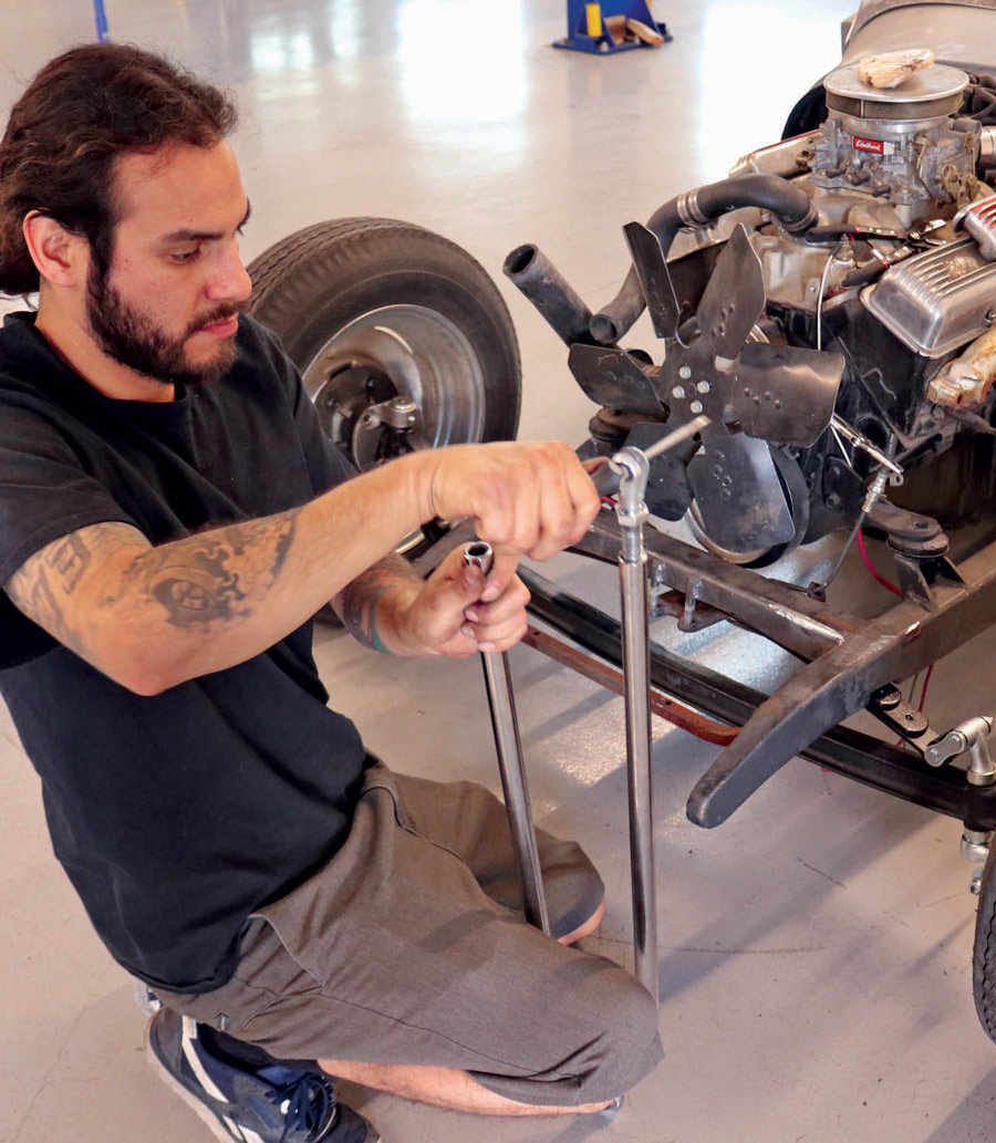 With the axle assembly installed under the Model A’s frame,  Arriero installs the clevis ends on the chromed Speedway radius rods and adjusts them evenly. 