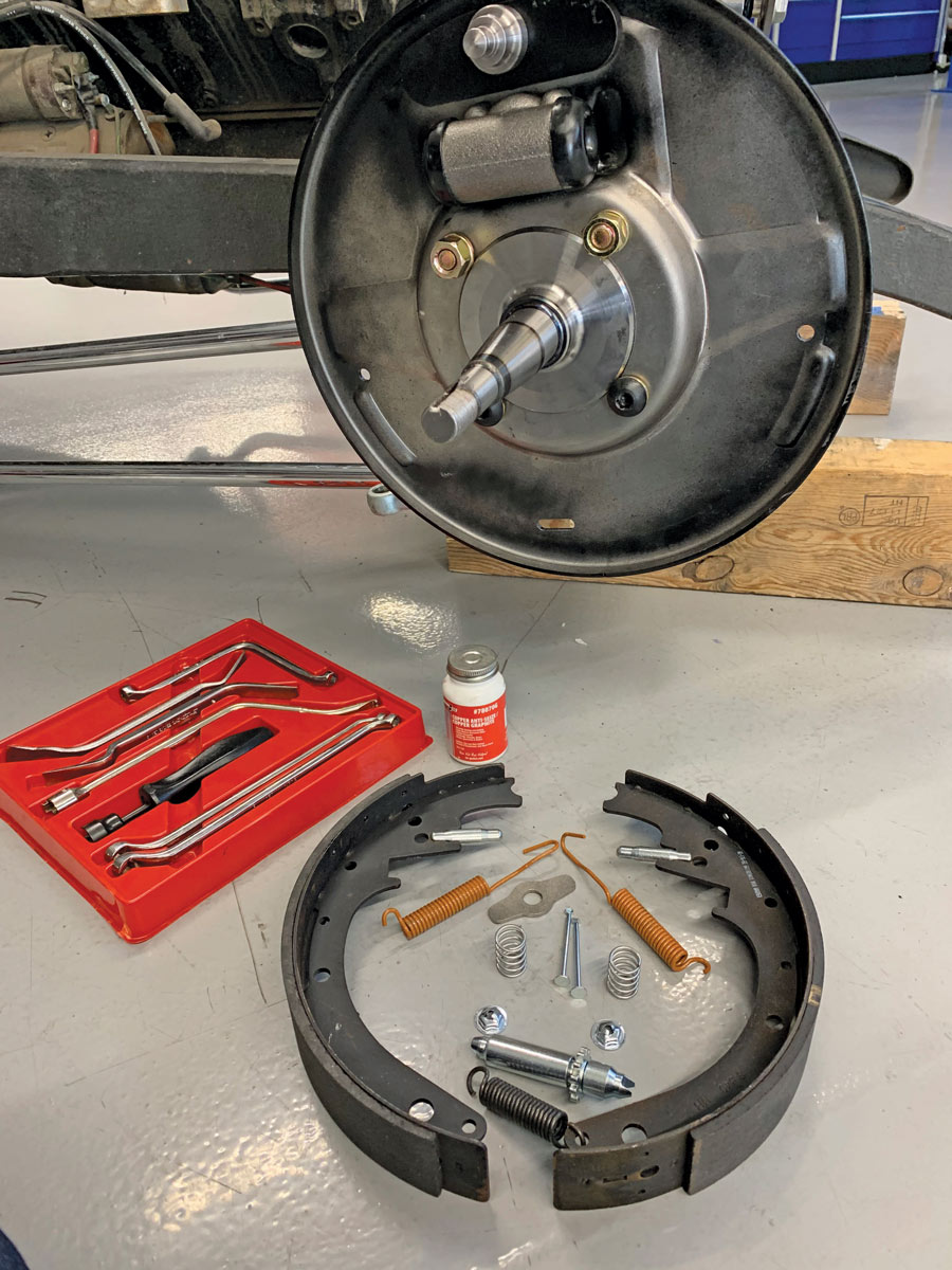 The Bendix-style backing plates are installed at the same time as the steering arms, save the internal components, along with the anchor pin and wheel cylinder. At this point, the anchor pin is left slightly loose.
