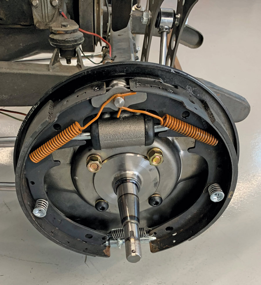 The shoe retaining plate is then placed over the anchor pin and the return springs installed, completing the installation of the internal components. 