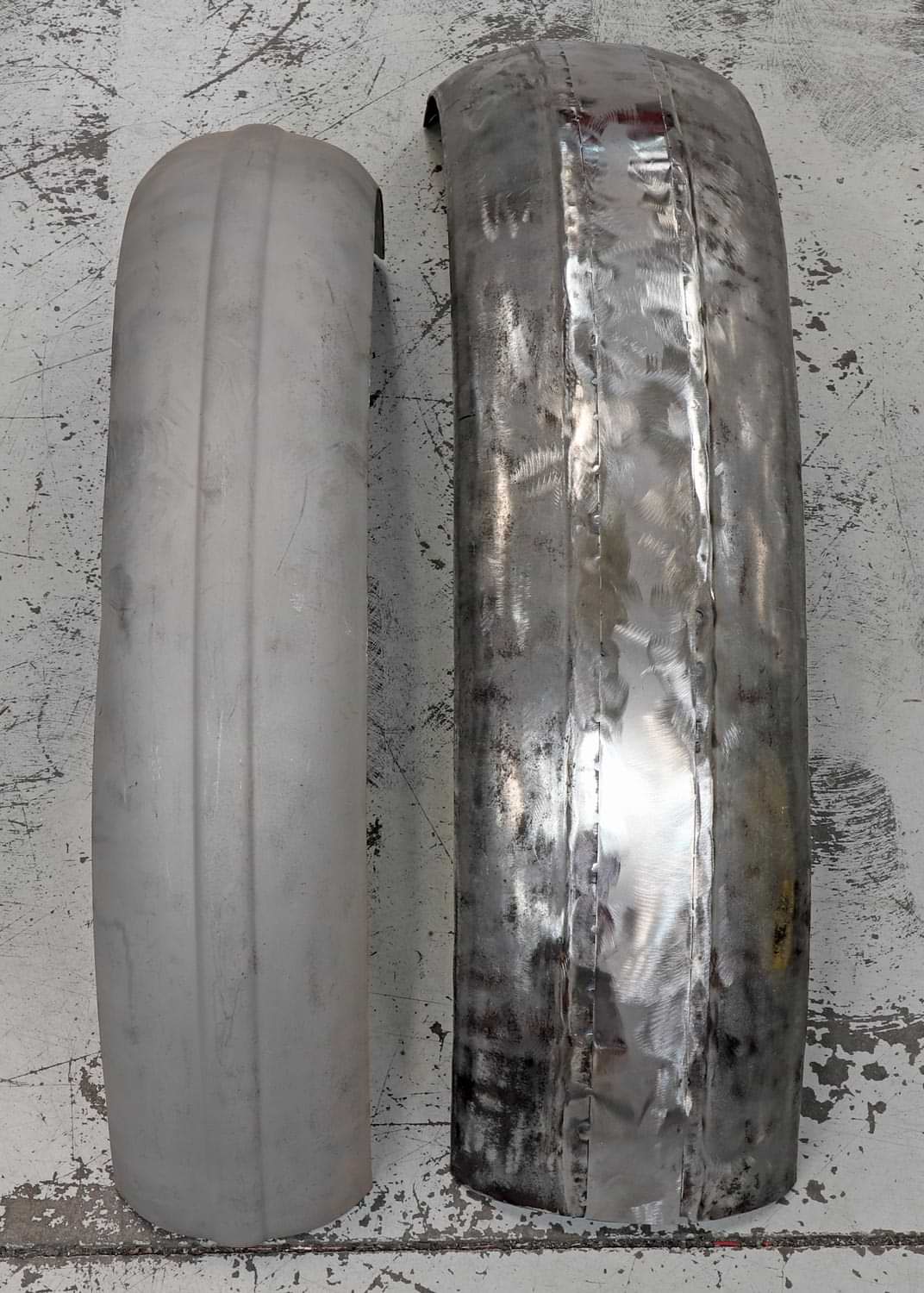 a front and rear fender sit side by side for comparison in width