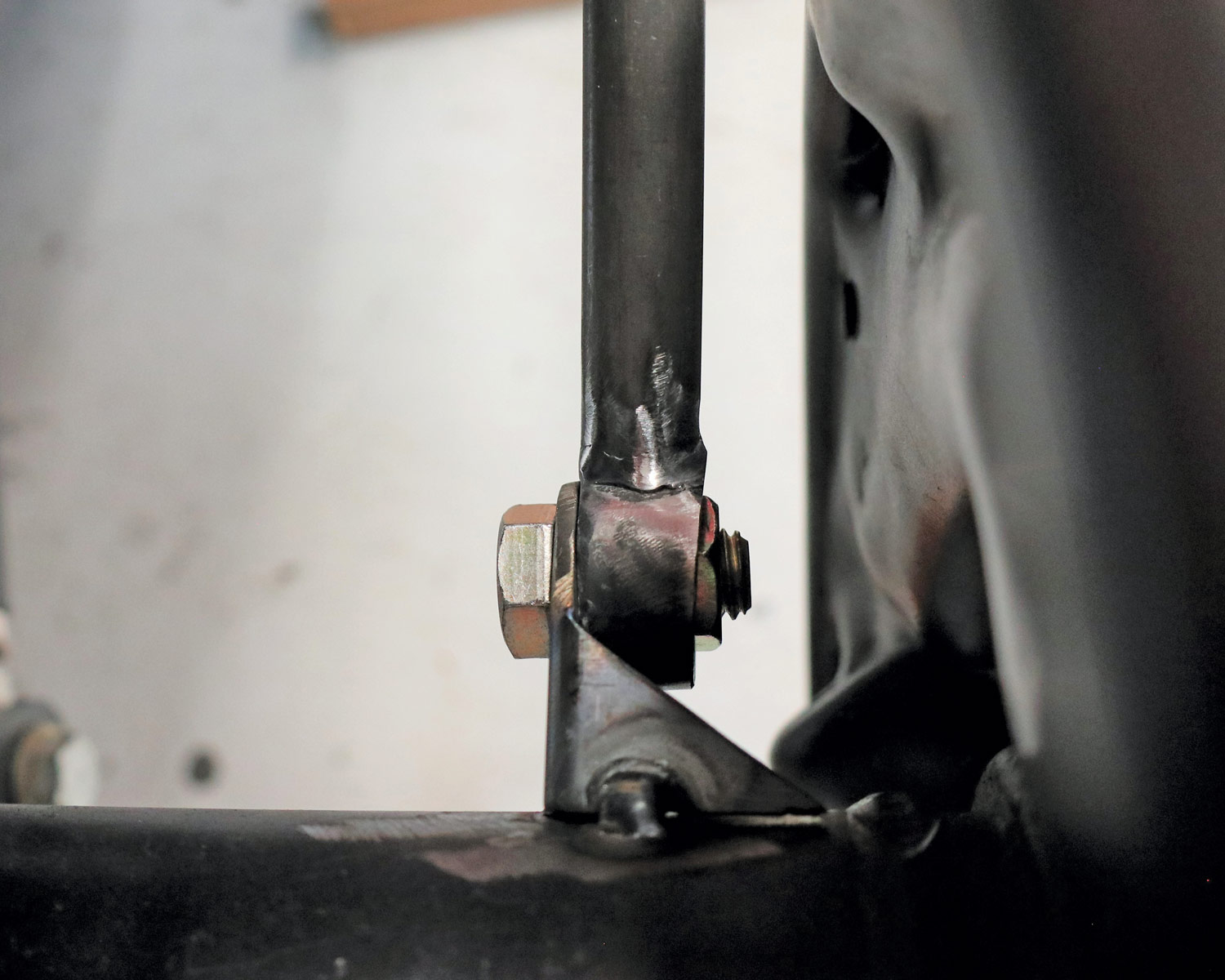 close view of the tubular stanchion welded to a boss for the mounting bolt