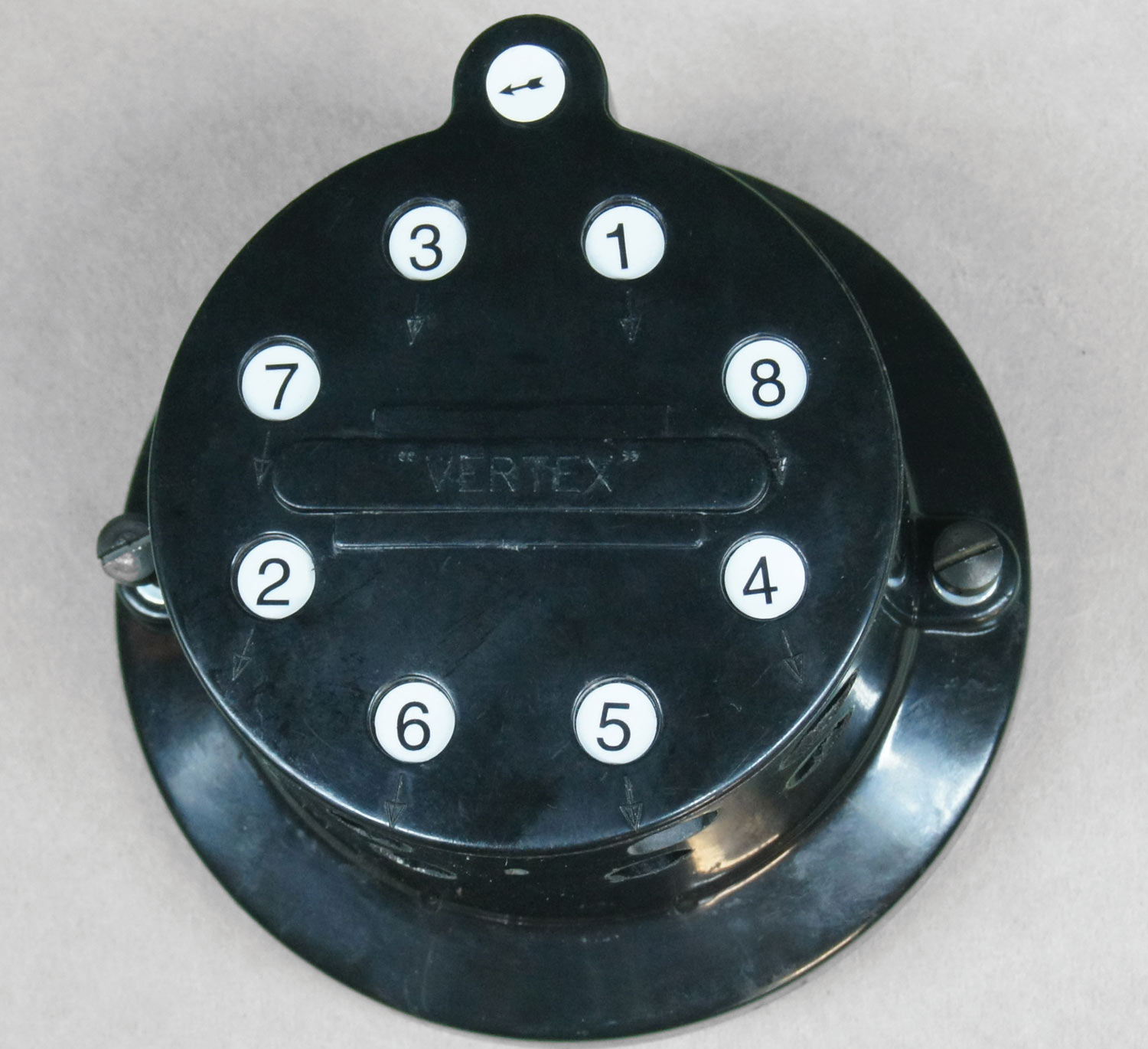 close view of a genuine Vertex cap complete with little round stickers that indicate the firing order and direction of rotation that you install for your engine