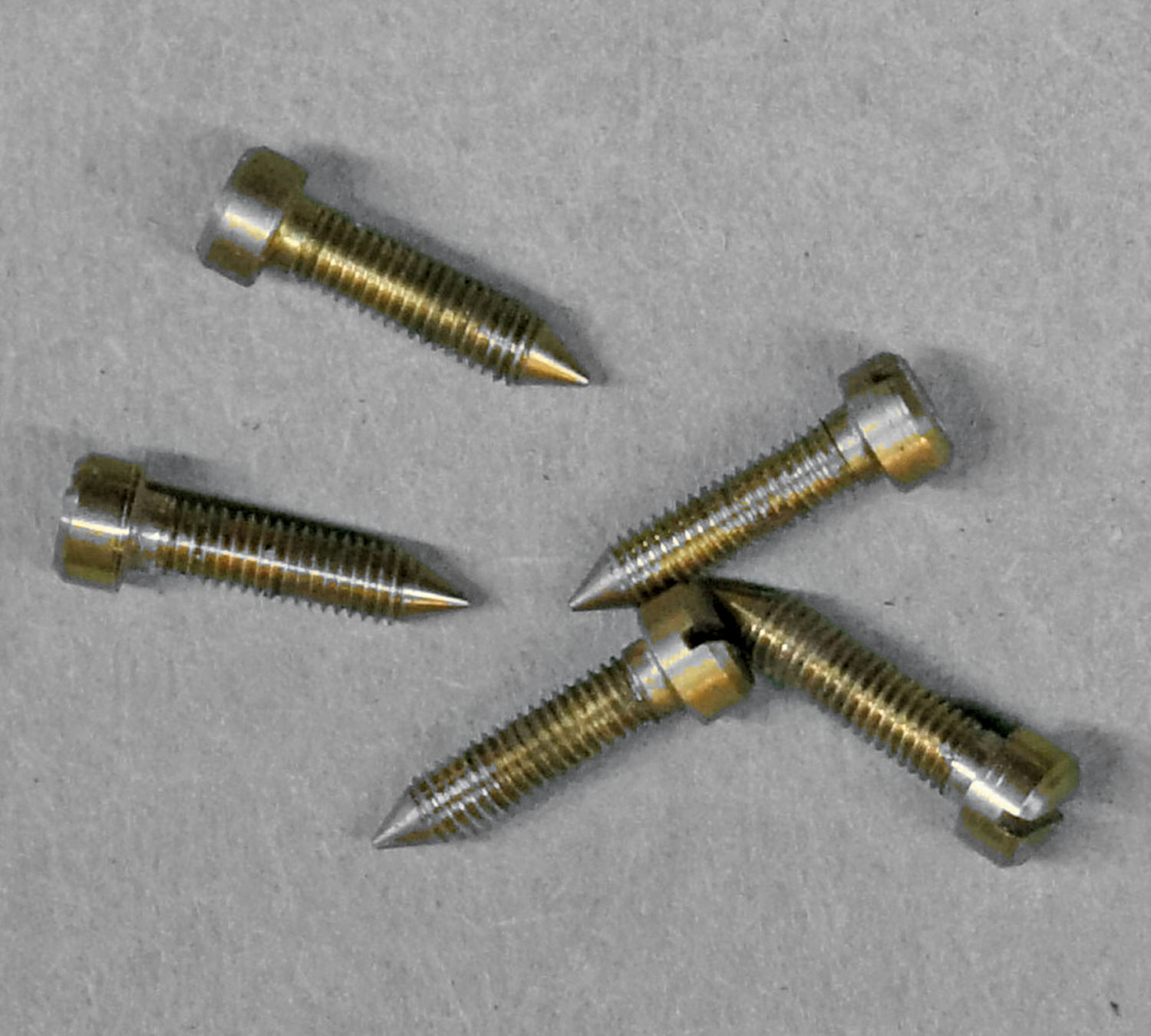 top view of five pointed screws sitting on a table awaiting installation