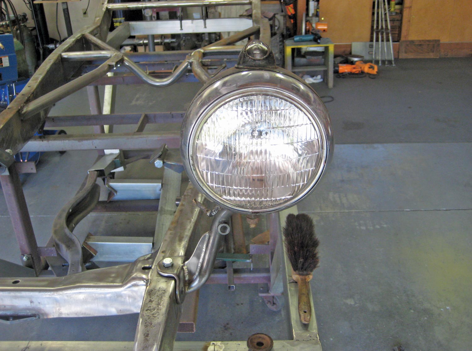 a now bolt-on headlight/shock absorber mount, bolted in place with a headlight