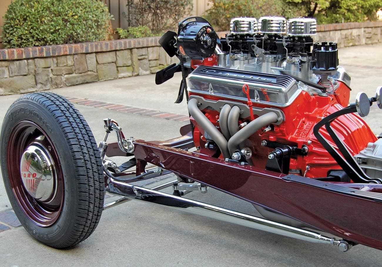 the burgundy chassis contrasting the chrome plating on the wishbones, axle, and shock mounts