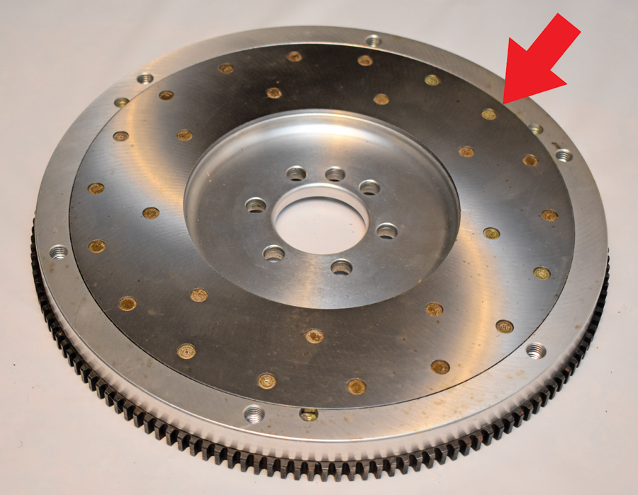 This is an aluminum flywheel, note it has a steel friction surface to go against the clutch disc (arrow). 