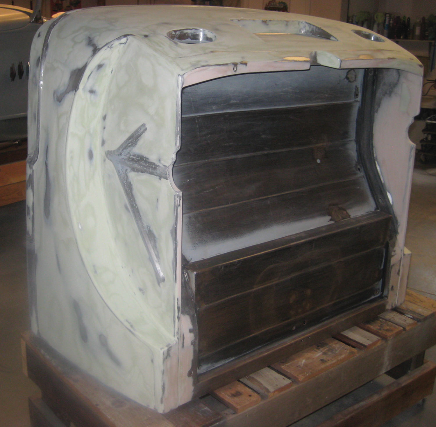 the back section of the body sits on its face, covered with a skim coat of filler