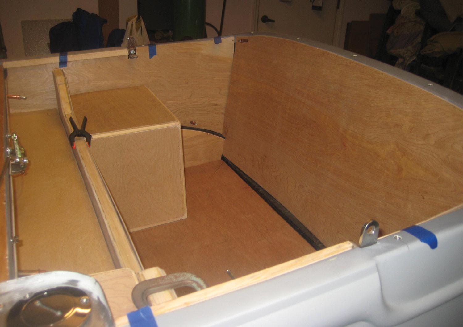 plywood panels run along the inside body of the car in preparation for the upholstery work